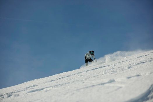 snowboard woman racing downhill slope and freeride on powder snow at winter season and sunny day