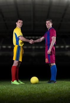 soccer player doing kick with ball on football stadium  field  isolated on black background