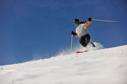 man ski free ride downhill at winter season on beautiful sunny day and powder snow