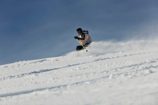 skier free ride downhill at winter season on beautiful sunny day 