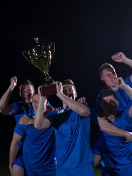 soccer players team group celebrating the victory and become champion of game while holding win coup