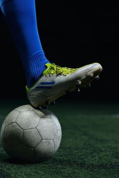 soccer player doing kick with ball on football stadium  field  isolated on black background