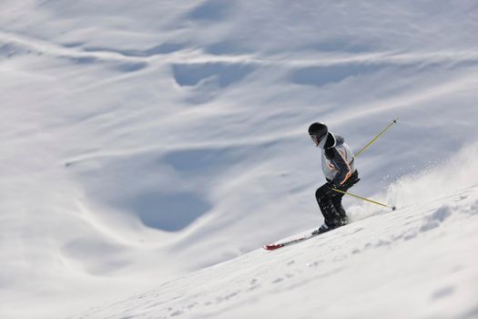 man ski free ride downhill at winter season on beautiful sunny day and powder snow