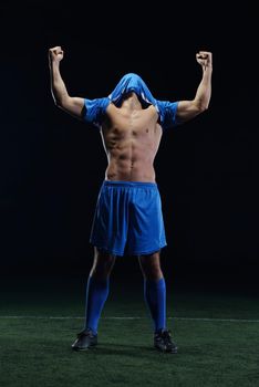 soccer player doing kick with ball on football stadium  field  isolated on black background