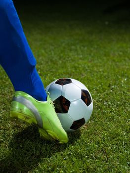 soccer player doing kick with ball on football stadium  field  isolated on black background