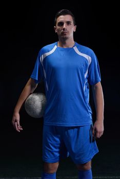 soccer player doing kick with ball on football stadium  field  isolated on black background