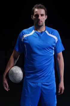 soccer player doing kick with ball on football stadium  field  isolated on black background