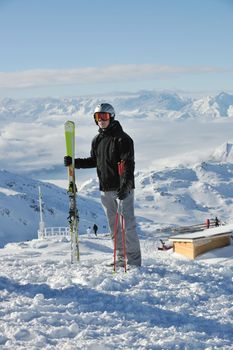 happy people group have fun on snow at winter season on mountain with blue sky and fresh air