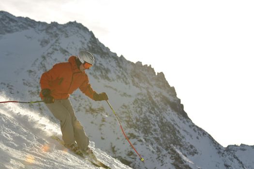 young athlete man have fun during skiing sport on hi mountain slopes at winter seasson and sunny day