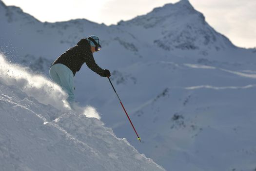 young healthy woman skiing on fresh snow at winter season in france alps