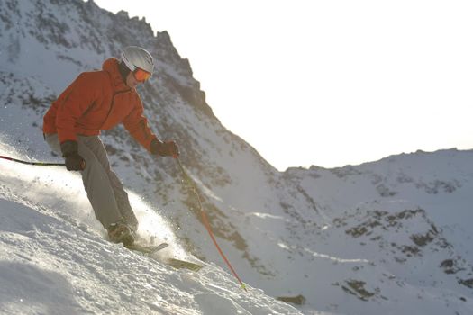 young athlete man have fun during skiing sport on hi mountain slopes at winter seasson and sunny day