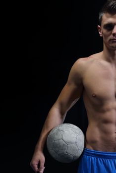 soccer player doing kick with ball on football stadium  field  isolated on black background