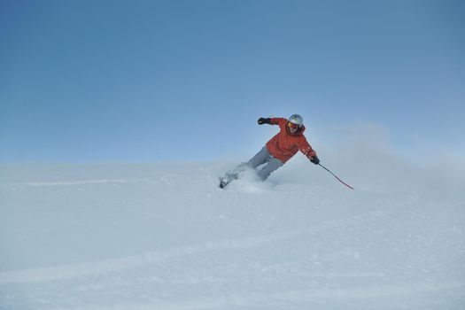 young athlete man have fun during skiing sport on hi mountain slopes at winter seasson and sunny day