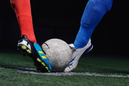 soccer player doing kick with ball on football stadium  field  isolated on black background