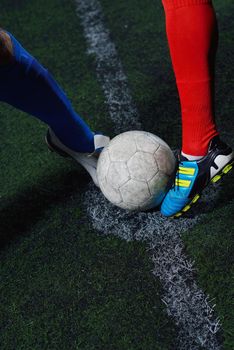 soccer player doing kick with ball on football stadium  field  isolated on black background