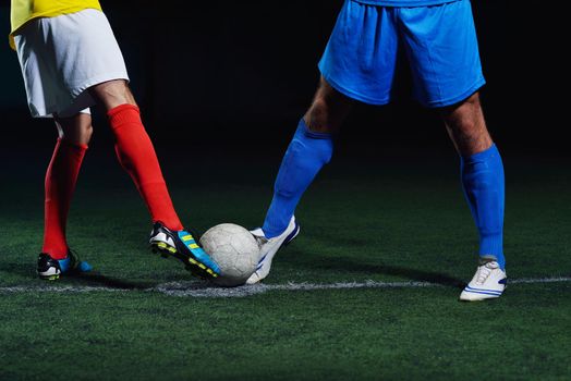 soccer player doing kick with ball on football stadium  field  isolated on black background