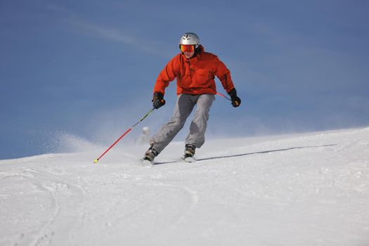 young athlete man have fun during skiing sport on hi mountain slopes at winter seasson and sunny day