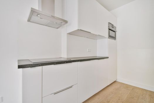 The interior of the kitchen area with a snow-white kitchen set