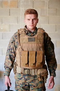 soldier preparing tactical protective and communication gear for action battle