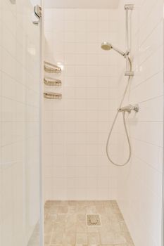 Modern shower stall in a bright bathroom