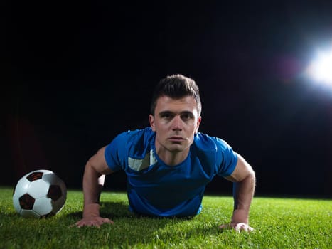 soccer player doing kick with ball on football stadium  field  isolated on black background