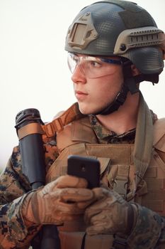 soldier using smart phone to contact family or girlfriend communication and nostalgia concept