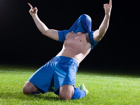 soccer player doing kick with ball on football stadium  field  isolated on black background