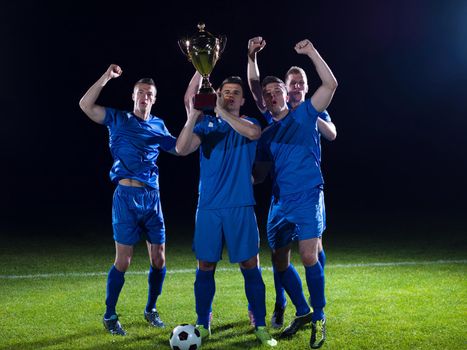 soccer players team group celebrating the victory and become champion of game while holding win coup