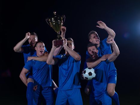 soccer players team group celebrating the victory and become champion of game while holding win coup