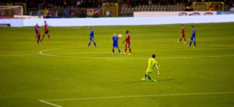 Soccer goalkeeper kicks out the ball during the match at stadium