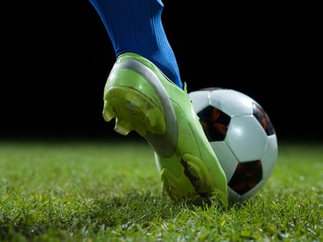 soccer player doing kick with ball on football stadium  field  isolated on black background