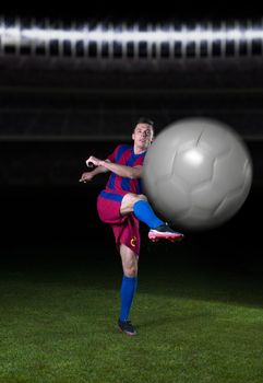 soccer player doing kick with ball on football stadium field