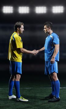 soccer player handshake on a football stadium before the game