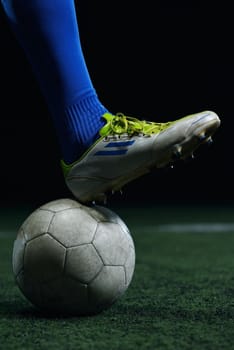 soccer player doing kick with ball on football stadium  field  isolated on black background