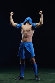 soccer player doing kick with ball on football stadium  field  isolated on black background