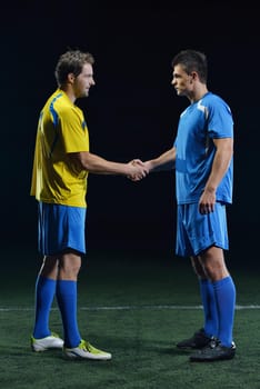 soccer player doing kick with ball on football stadium  field  isolated on black background