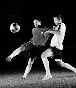 competition Action run and jump Duel of football players at soccer ball stadium at night