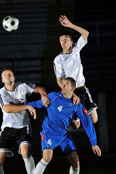 competition Action run and jump Duel of football players at soccer ball stadium at night