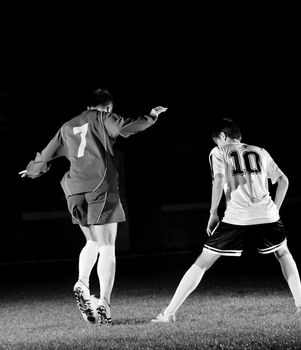 competition Action run and jump Duel of football players at soccer ball stadium at night