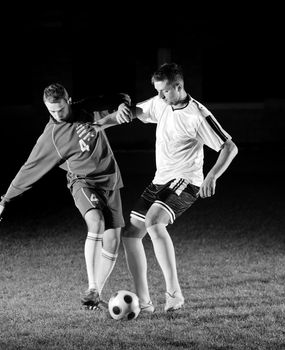 competition Action run and jump Duel of football players at soccer ball stadium at night