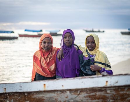 Group of Muslim girls together on the beach