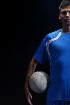 soccer player doing kick with ball on football stadium  field  isolated on black background