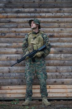 soldier portrait with  protective army tactical gear  and weapon having a break and relaxing