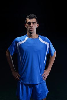 soccer player doing kick with ball on football stadium  field  isolated on black background