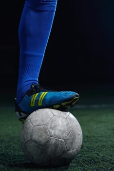 soccer player doing kick with ball on football stadium  field  isolated on black background