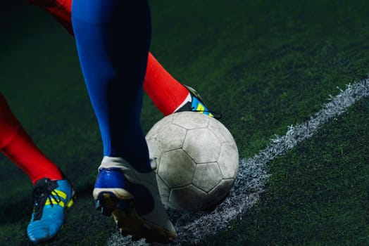 soccer player doing kick with ball on football stadium  field  isolated on black background