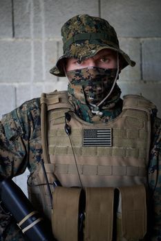 soldier portrait with  protective army tactical gear  against old brick wall