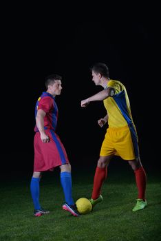 soccer player doing kick with ball on football stadium  field  isolated on black background