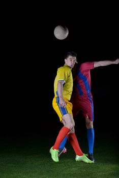 soccer player doing kick with ball on football stadium  field  isolated on black background