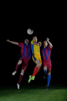 soccer player doing kick with ball on football stadium  field  isolated on black background